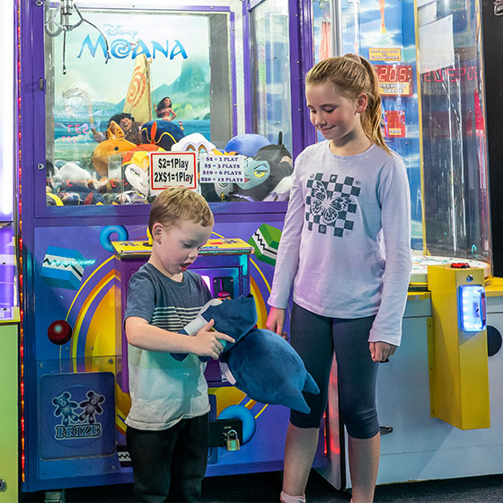 Kids playing with toy won at Sunset Superbowl arcade