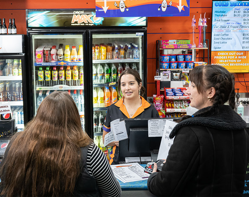 Sunset Superbowl team member helping customers with their food order